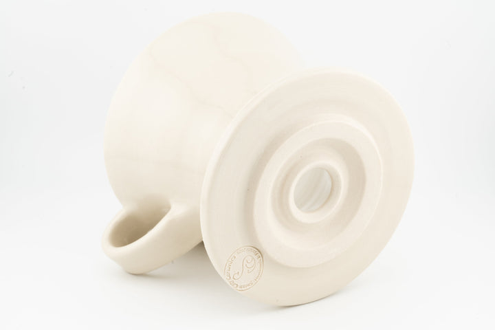 V60 ceramic coffee dripper underside with circular vent, matte white glaze, side handle.