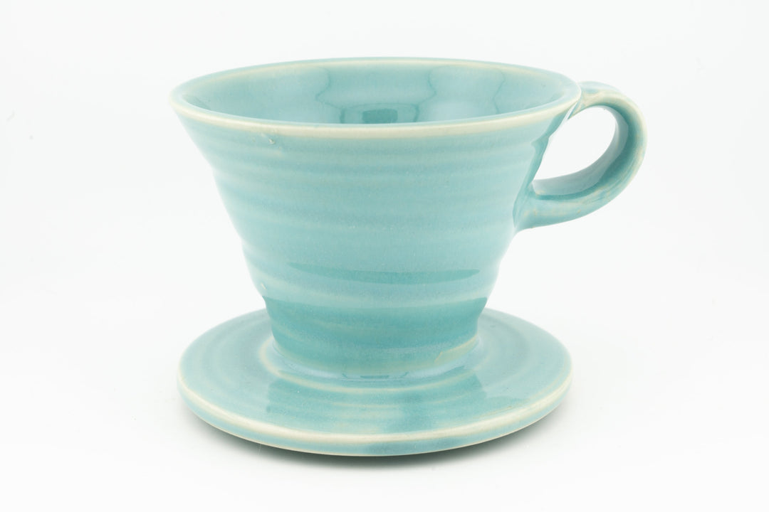 V60 ceramic coffee dripper with drip stand, light turquoise glaze and side handle.