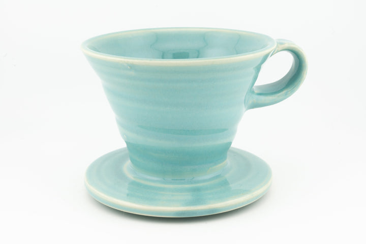 V60 ceramic coffee dripper with drip stand, light turquoise glaze and side handle.