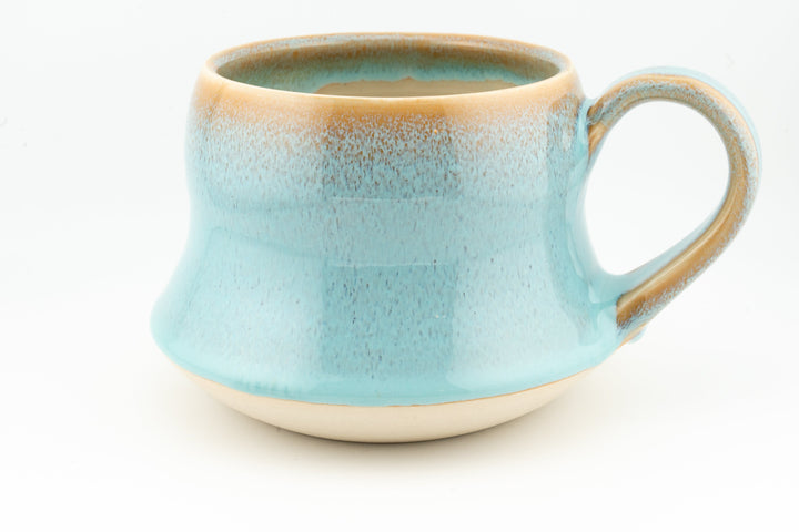 Wide ceramic mug with turquoise-blue glaze, loop handle, and speckled texture