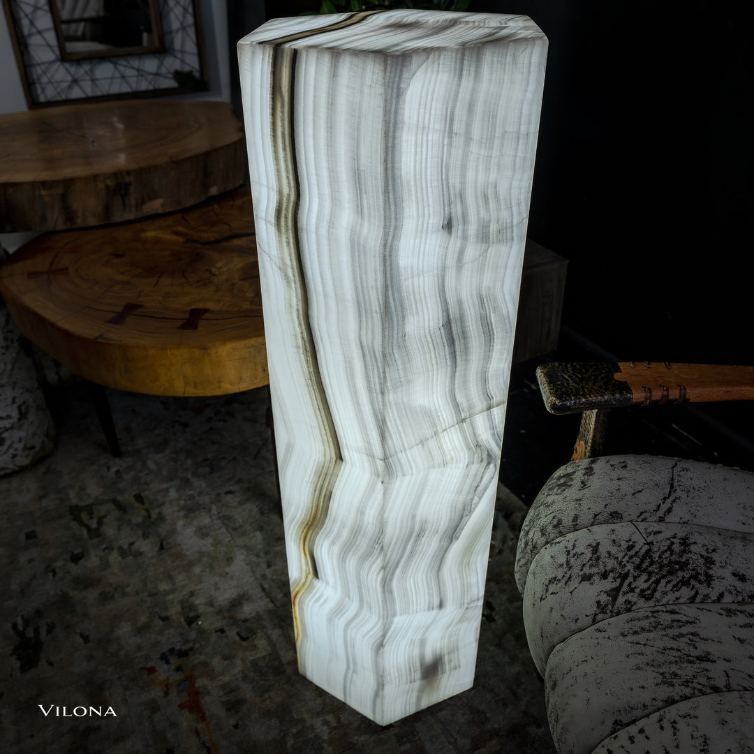 White onyx floor lamp front three-quarter view, hexagonal column shade with striations