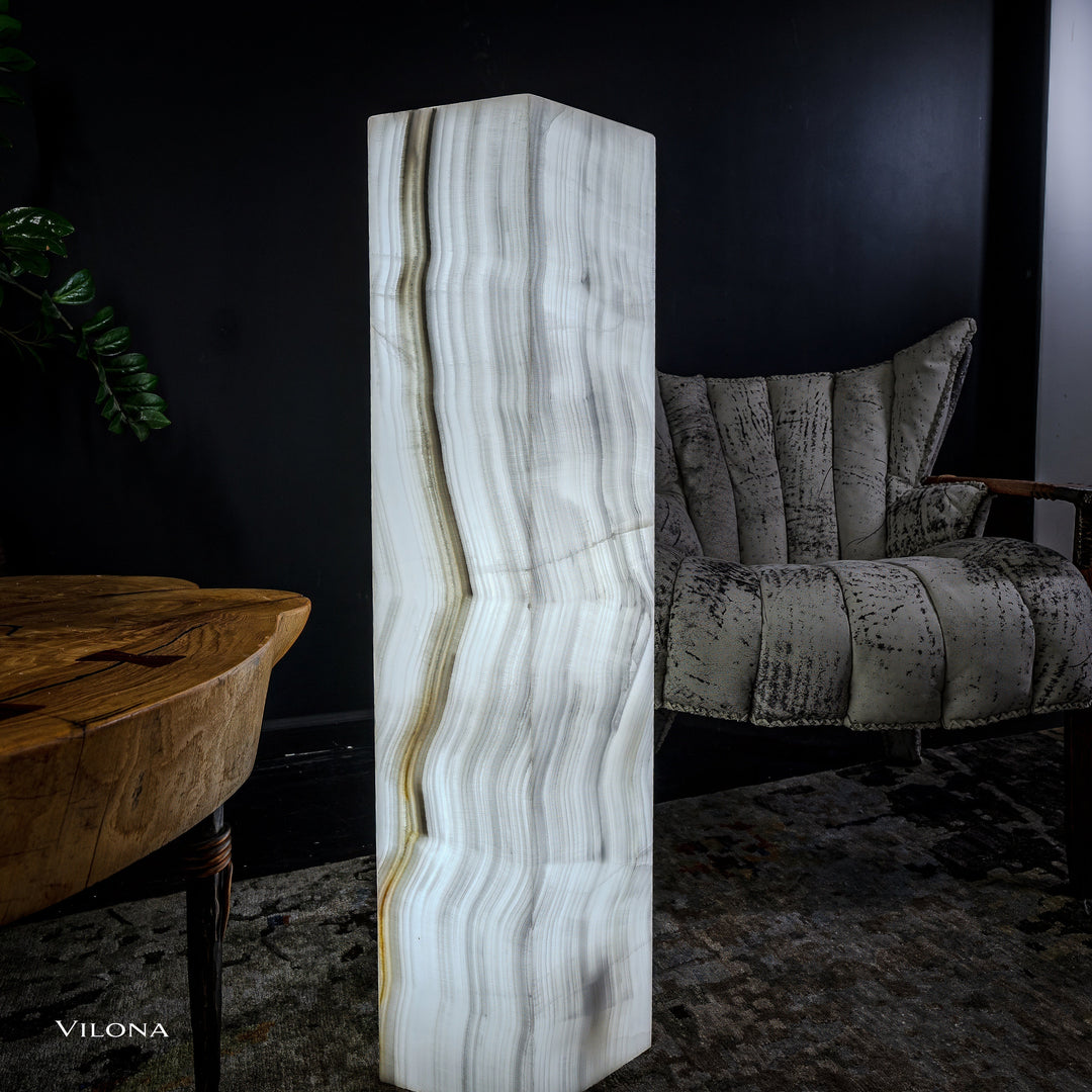 White onyx floor lamp standing view, tall hexagonal shade with vertical veined stripes