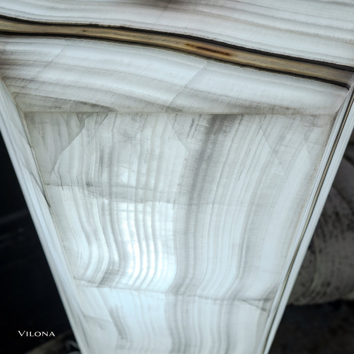 White onyx floor lamp shade close-up with vertical wavy striations and thin dark bands