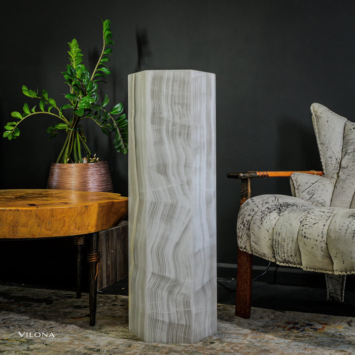 Small white onyx floor lamp standing tall with clear vertical striations on column