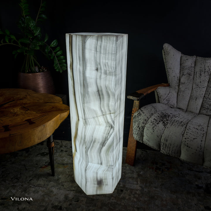 White onyx floor lamp standing view, hexagonal column shade with flowing vertical lines