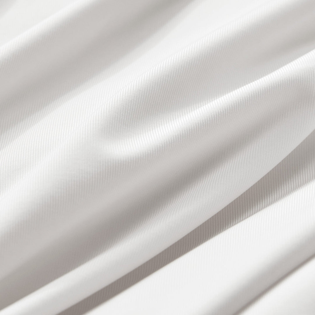 White pillowcase fabric close-up with fine textured weave