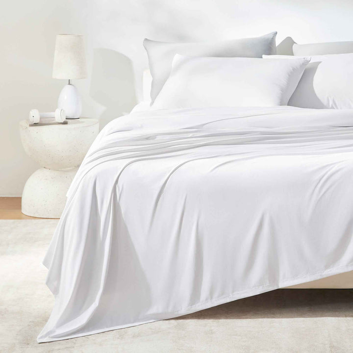 White sheet set with pillowcases and flat sheet on a bed