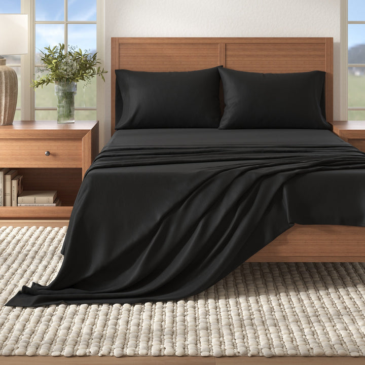 Cotton solid flannel sheet set, dark black on a bed with matching pillowcases