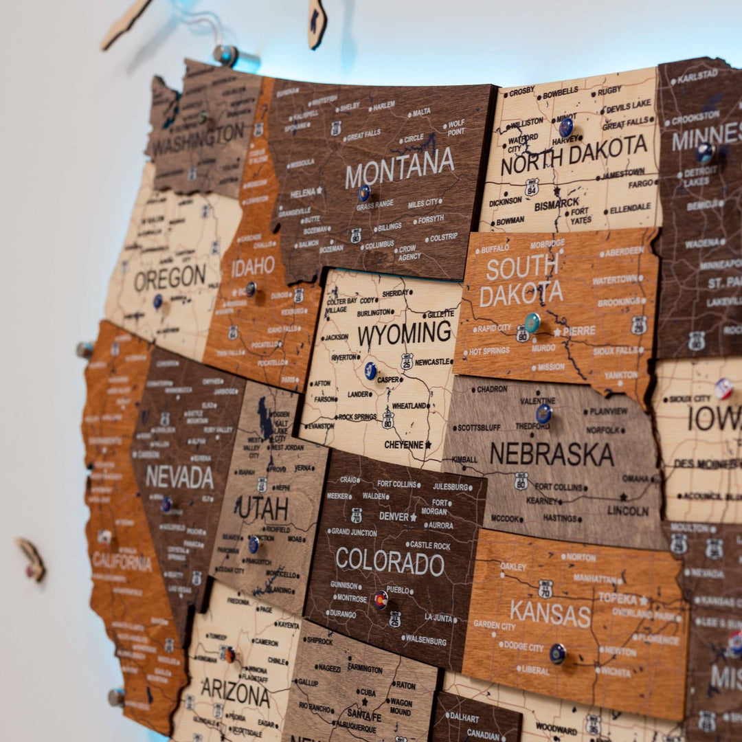Close-up of wooden 3D LED USA map showing multicolor state names and waterways