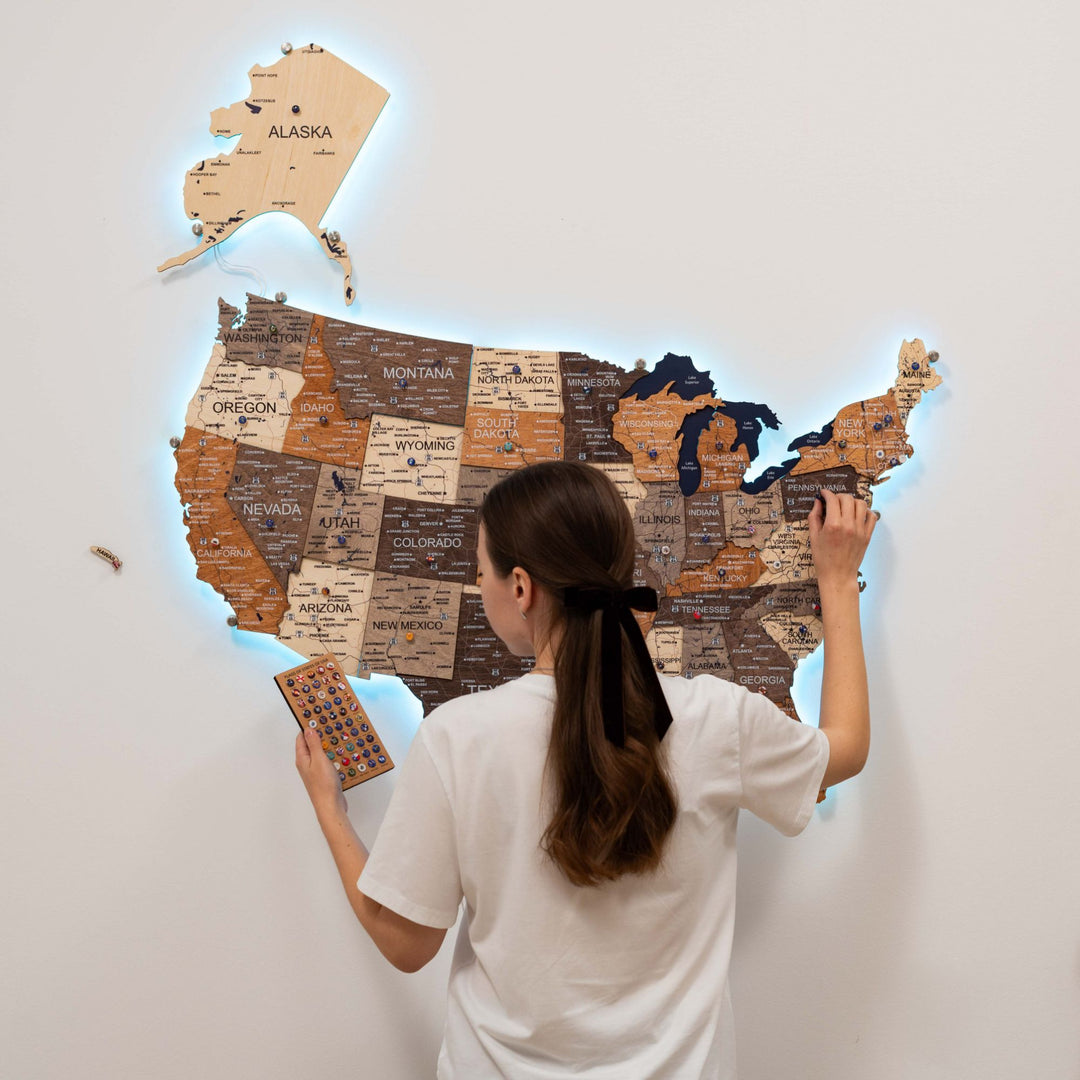 Wooden 3D LED USA map with multicolor states and warm LED glow, shown while placing pieces