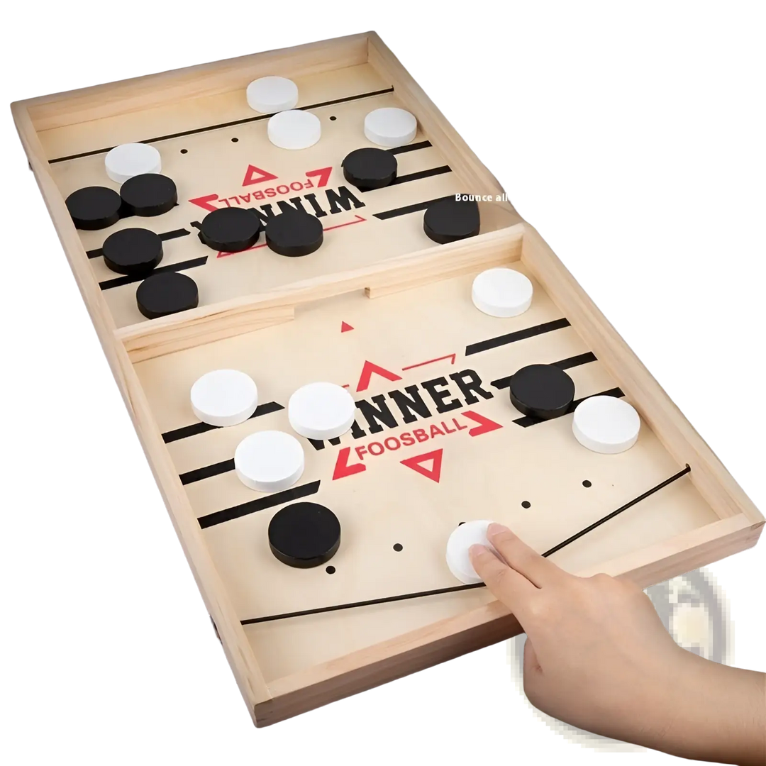 Angled desktop puck game board with black and white discs and a hand near the rail