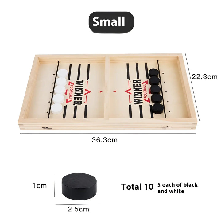 Small desktop puck game board with black and white discs in two playing lanes