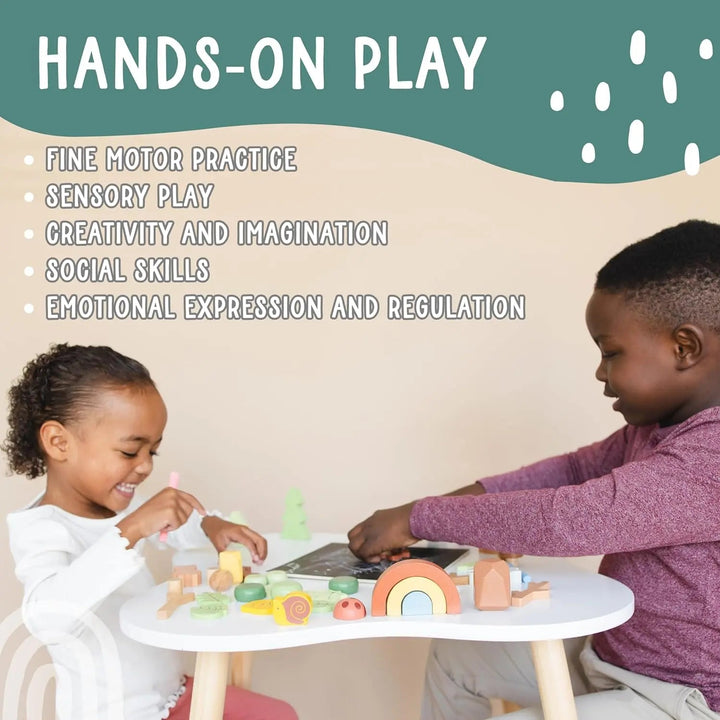 Wooden forest sensory bin on round table with wooden trees, animals and rainbow