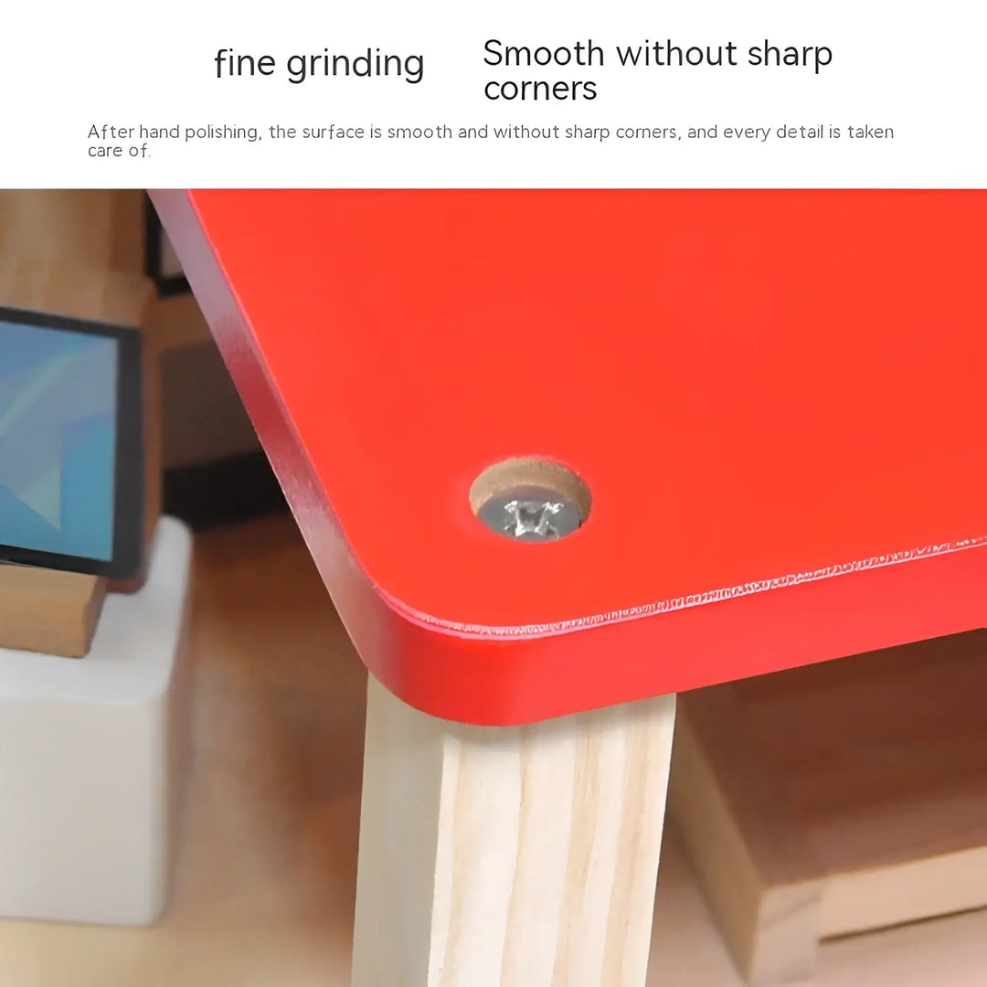 Close-up of smooth red plastic panel and wooden post with visible screw on toy playset