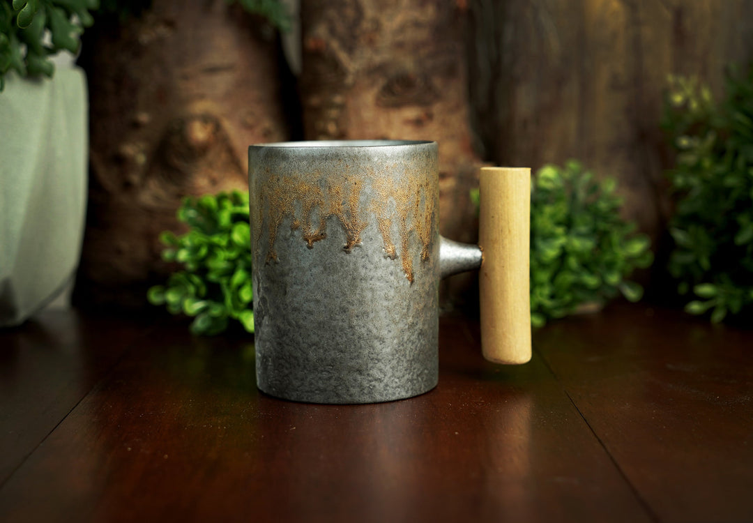 Glazed ceramic mug with wooden handle, iron bronze drip-style glaze
