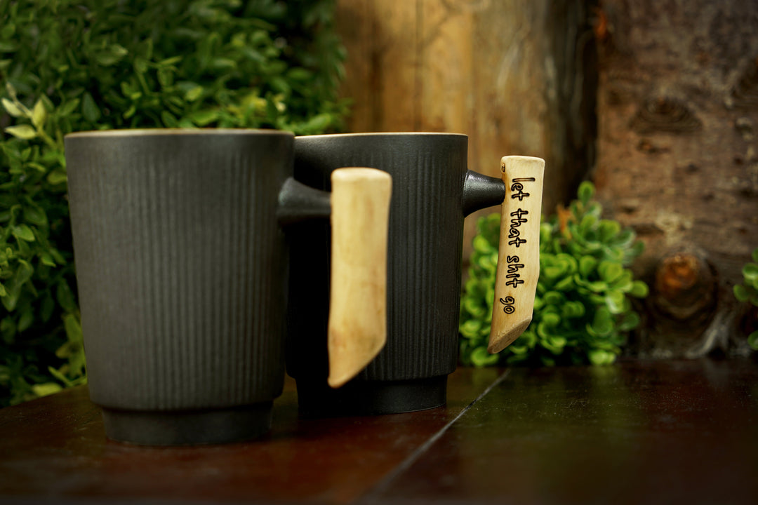 Dark ribbed ceramic mug with mint interior, light wood handle with engraved text