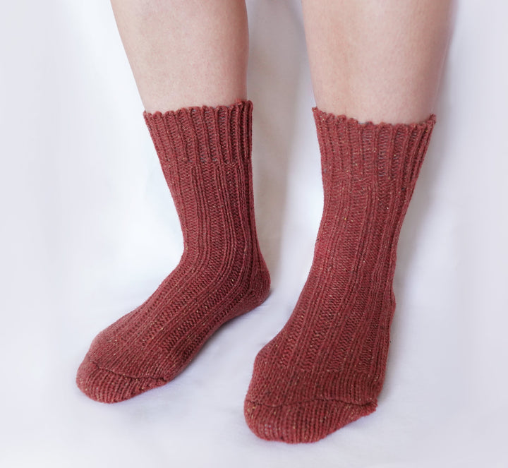 Women’s wool-silk crew socks on legs in rust orange