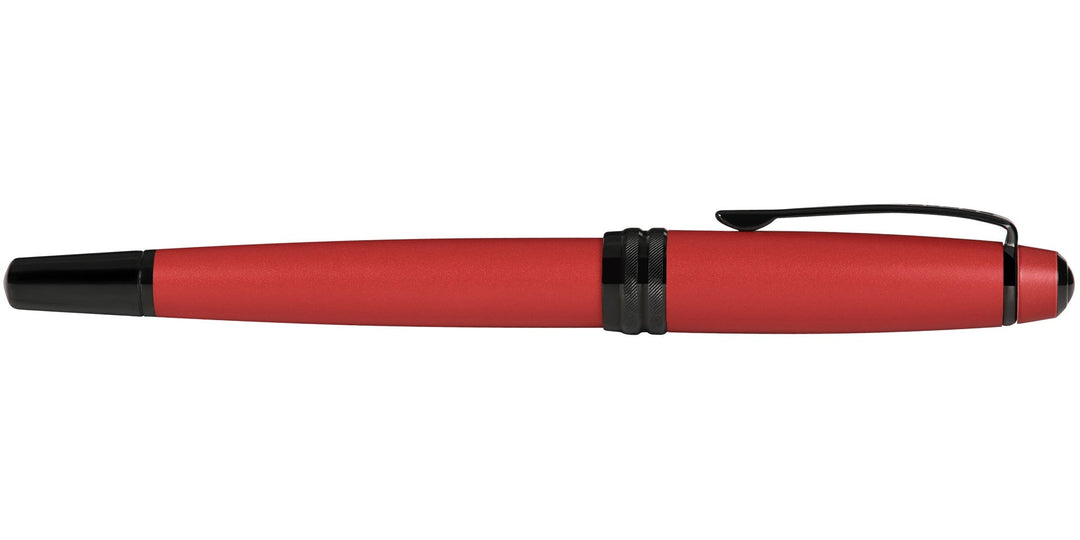 Matte red rollerball pen with black tip and clip, angled side profile