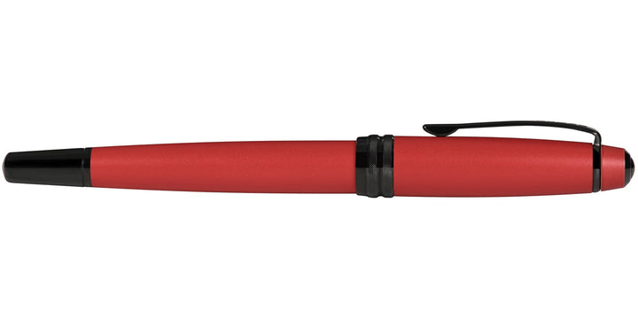 Matte red rollerball pen with black tip and clip, angled side profile