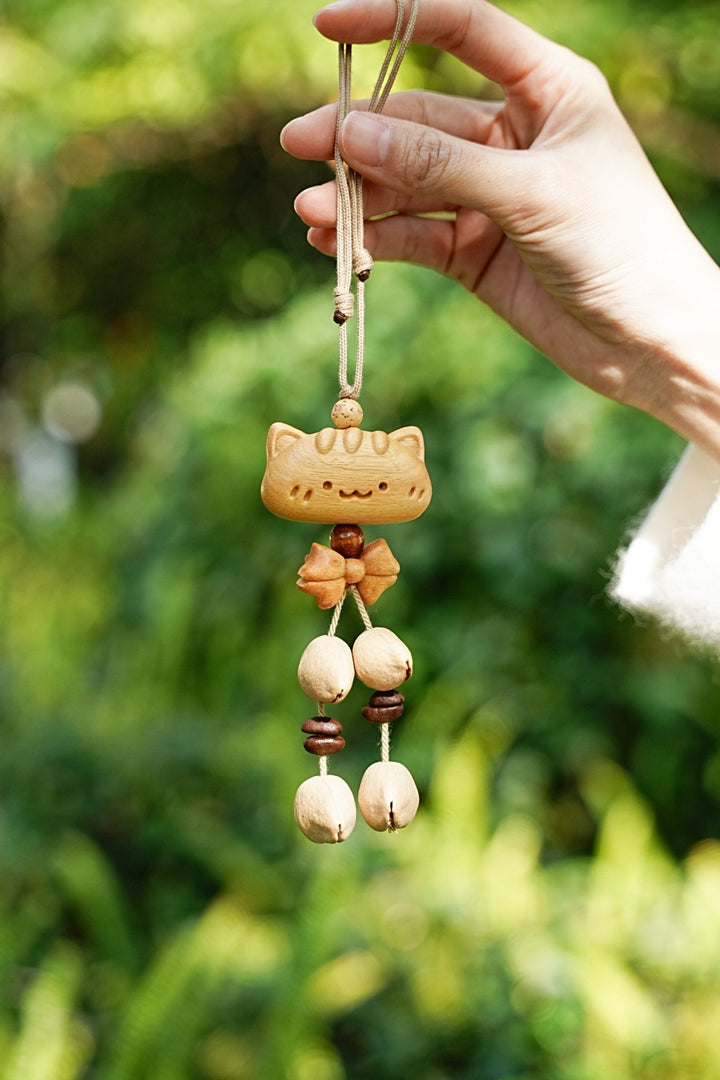 Wooden animal seed bag charm with hanging beads and small figurine