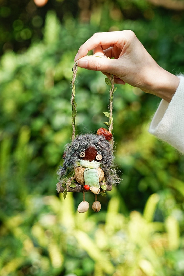 Felt animal seed bag charm with leaf, acorn, and dangling charms