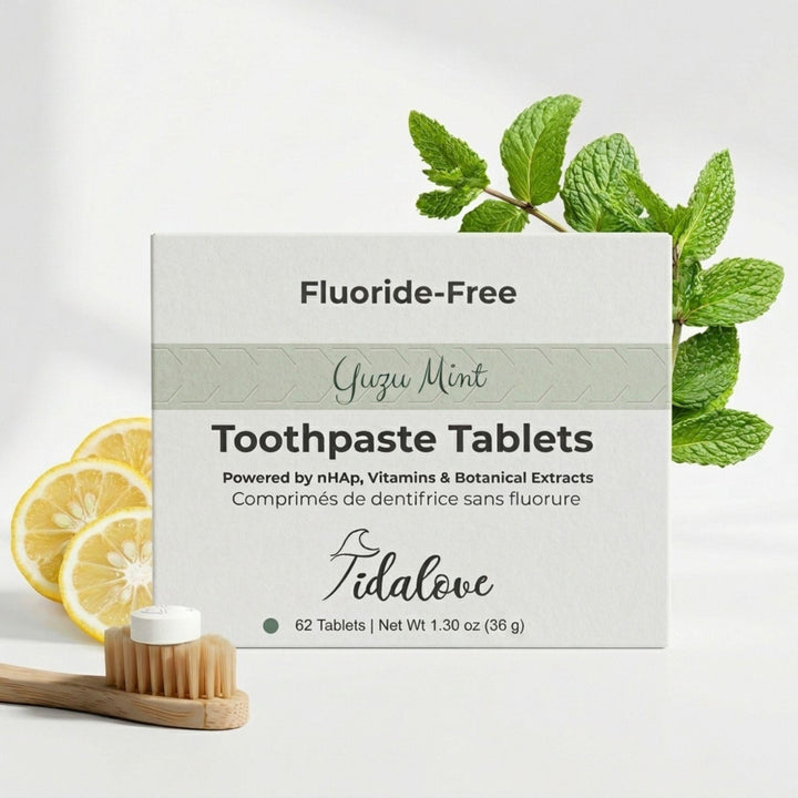 Toothpaste tablets box with yuzu mint theme, shown with wooden toothbrush and mint leaves