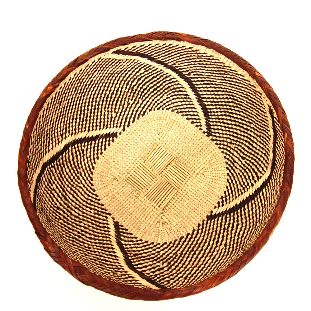 Round woven basket bowl in tan with dark brown swirl and diamond accents